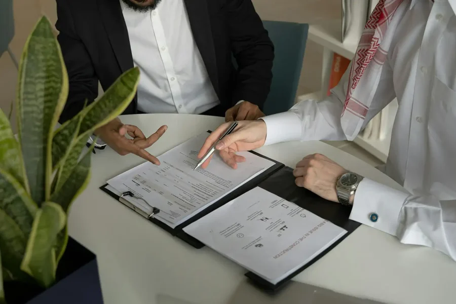 Two business advisers reviewing documents together during a consultation